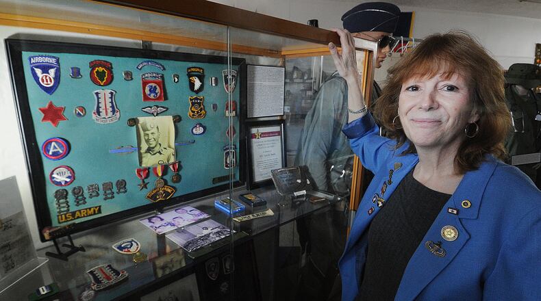 Catherine Beers-Conrad's is the spokeswoman for the Miami Valley Military History Museum at 4 E. Main St., in Fairborn. Beers-Conrad's stands by her father's display at the museum. Her father died during the Vietnam War. MARSHALL GORBY\STAFF