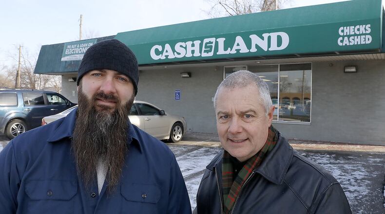 Carl Ruby, pastor of the Central Christian Church, right, and Derek Drewery, pator New Day Christian Fellowship, talk about the high interest rates at payday lenders in the Springifeld area. Bill Lackey/Staff