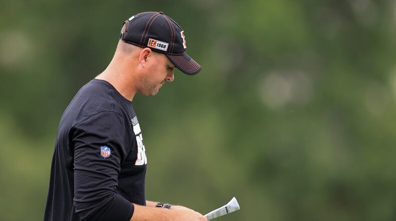 Cincinnati Bengals head coach Zac Taylor stands on the field during NFL football practice in Cincinnati, Tuesday, June 8, 2021. (AP Photo/Aaron Doster)