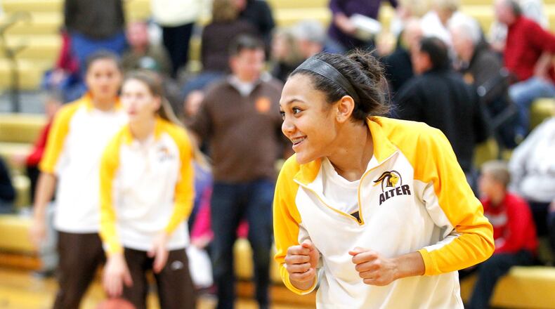 Alter’s Braxtin Miller (24) warms up with her teammates before Tuesday’s game against McAuley at McAuley High School in Cincinnati Dec. 3, 2013. NICK DAGGY / STAFF