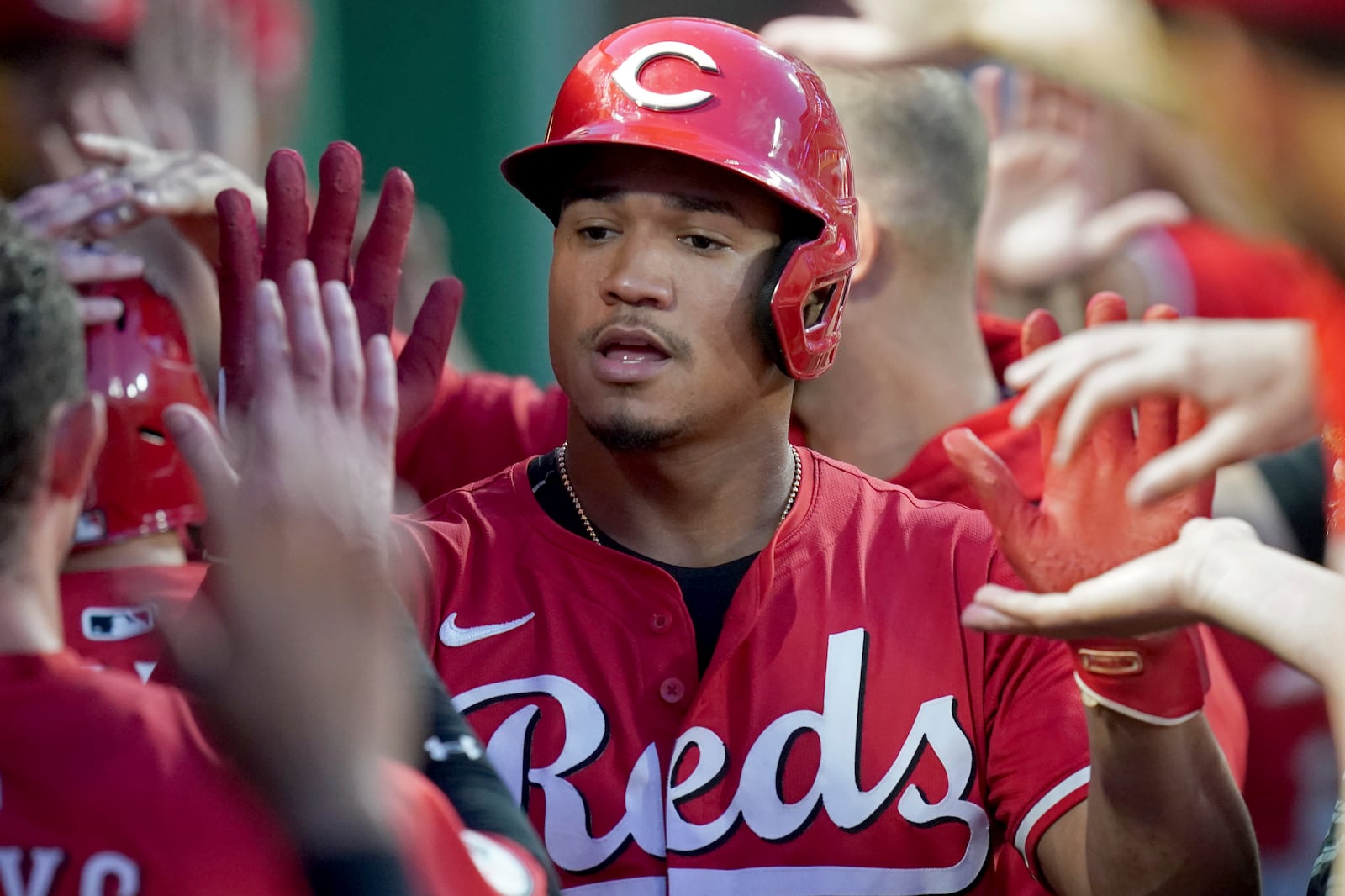 Cincinnati Reds' Noelvi Marte celebrates in the dugout after scoring during the seventh inning of a baseball game against the Pittsburgh Pirates, Saturday, Aug. 9, 2025, in Pittsburgh. (AP Photo/Matt Freed)