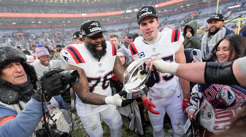 New England Patriots offensive tackle Morgan Moses (76) and tight end Hunter Henry celebrate after the AFC Championship NFL football game against the Denver Broncos, Sunday, Jan. 25, 2026, in Denver. (AP Photo/Ashley Landis)