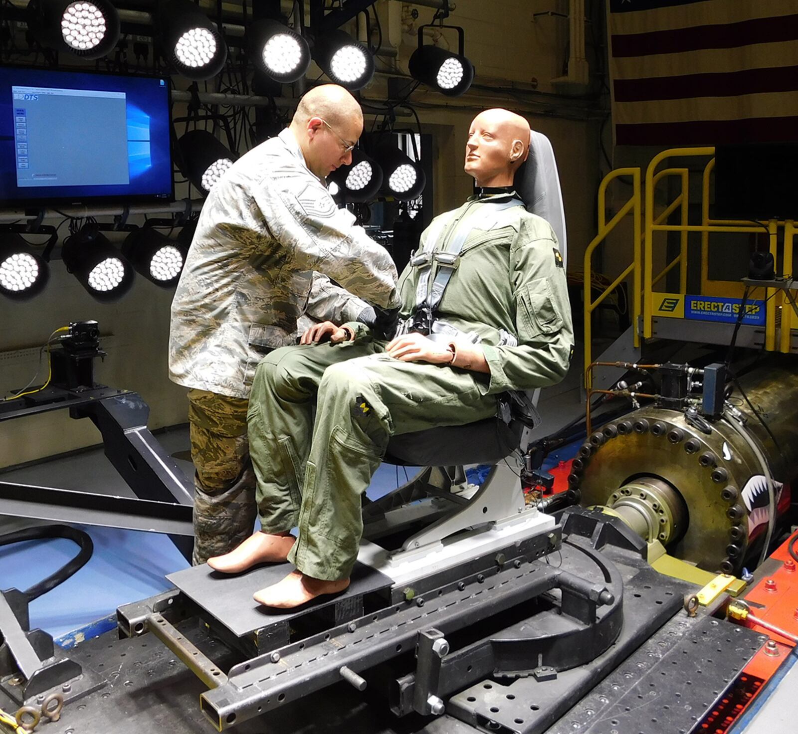 Master Sgt. James Chase of Air Force Research Laboratory’s 711th Human Performance Wing Biodynamics team prepares an instrumented 250-pound test device, simulating a human occupant, for seat testing on the Horizontal Impulse Accelerator, located at Wright-Patterson Air Force Base. The test is one of a series recently conducted to support the acceptance and implementation of the Portable Biocontainment Care Module, which will aid in the safe transport of personnel affected by infectious diseases, including COVID-19. COURTESY PHOTO/INFOSCITEX CORP., CHRISTOPHER ALBERY