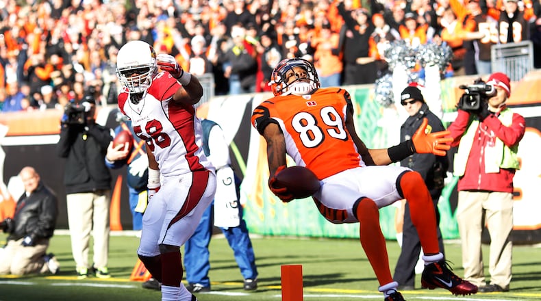 CINCINNATI, OH - DECEMBER 24: Jerome Simpson #89 of the Cincinnati Bengals jumps over Daryl Washington #58 of the Arizona Cardinals for a 19-yard touchdown during first half action at Paul Brown Stadium on December 24, 2011 in Cincinnati, Ohio. (Photo by Joe Robbins/Getty Images)