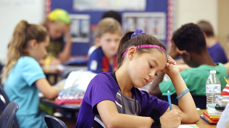 McKenna Myer, a fourth grade student at Northmoor Elementary School in Englewood, writes in a journal during class. The practice is an effort to address social-emotional skills. LISA POWELL / STAFF