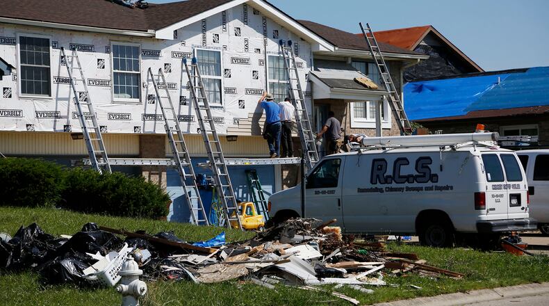 A fraction of repairs to homes and apartments has been completed after the Memorial Day tornadoes struck. This duplex on North Knoll Drive in Beavercreek was getting new siding and roof repair in this photo from late June. TY GREENLEES / STAFF