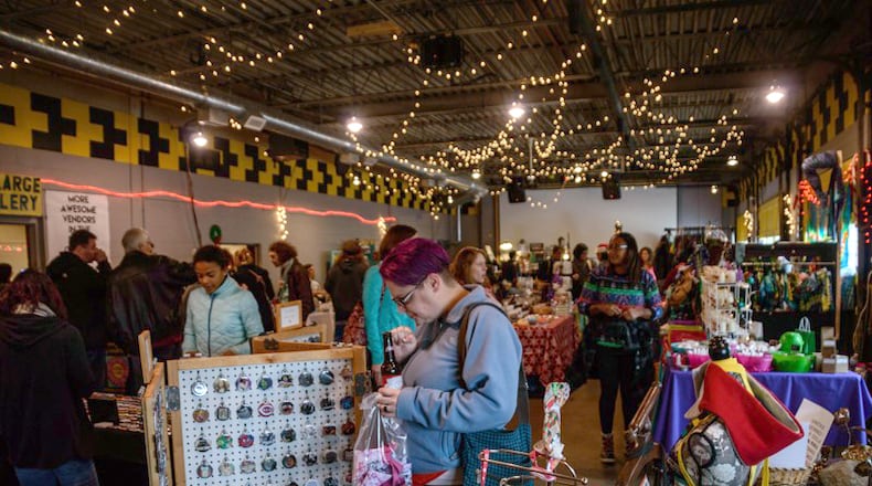 Local vendors set up shop with handmade wares to give and get for the holidays at the Yellow Cab Tavern in Dayton. TOM GILLIAM/FILE