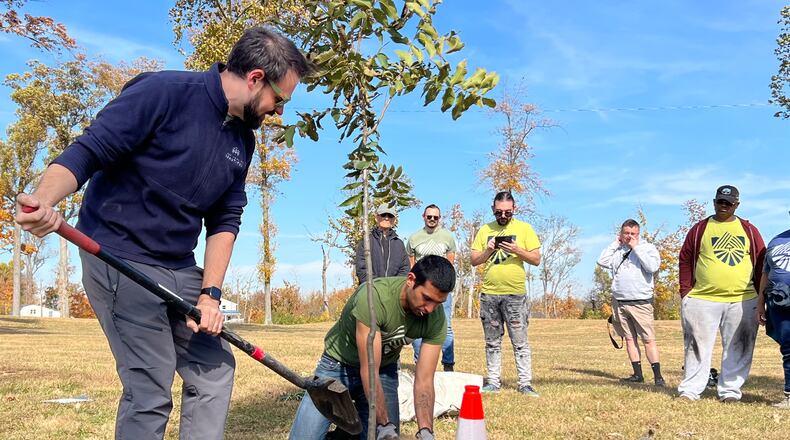 Volunteers for Saturday's TREEcovery Campaign planting event get briefed on tree planting techniques by RETREET Director Grady McGahan, left, before heading out into the community. AIMEE HANCOCK/STAFF