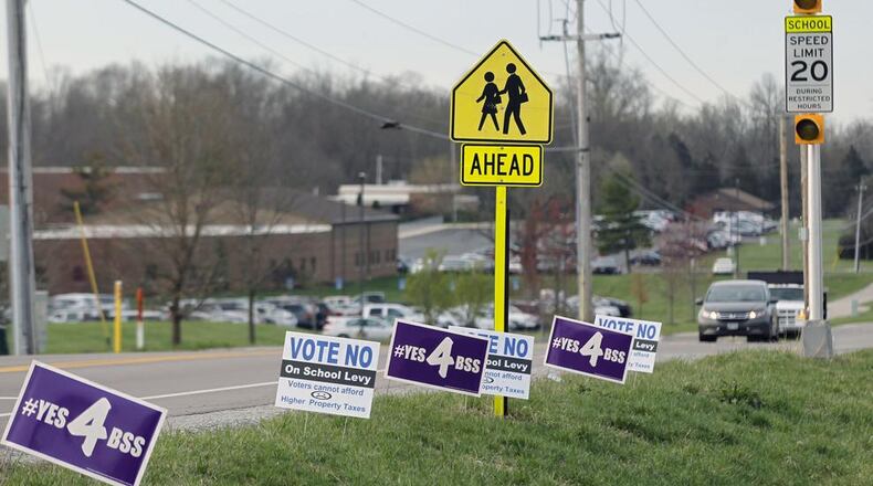 Political signs dotted the sides of roadways in the Bellbrook-Sugarcreek school district in May 2019. TY GREENLEES/STAFF