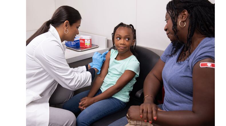 Mother and daughter get flu vaccinations at a CVS Pharmacy. COURTESY OF CVS HEALTH