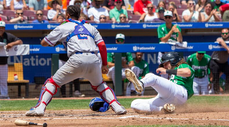 Garrett Wolforth scores while an overthrow is being retrieved at the backstop during the Dragons' five-run third inning on Sunday against South Bend at Day Air Ballpark.