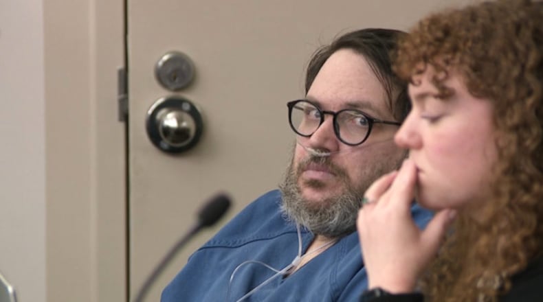 In this image captured from video, Nicholas Rossi, left, appears in a Salt Lake City court, Monday, Oct. 20, 2025, for his sentencing hearing on a rape conviction. To his right is MacKenzie Potter of the Salt Lake Legal Defender Association. (Fox 13/Pool Video via AP)
