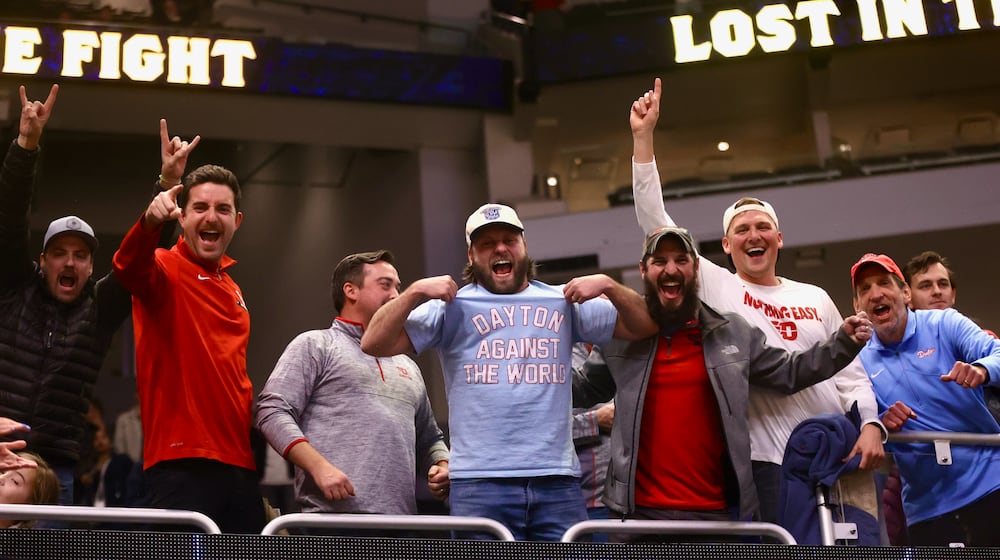 Dayton fans celebrate after a victory against Marquette on Wednesday, Nov. 19, 2025, at Fiserv Arena in Milwaukee, Wis. David Jablonski/Staff
