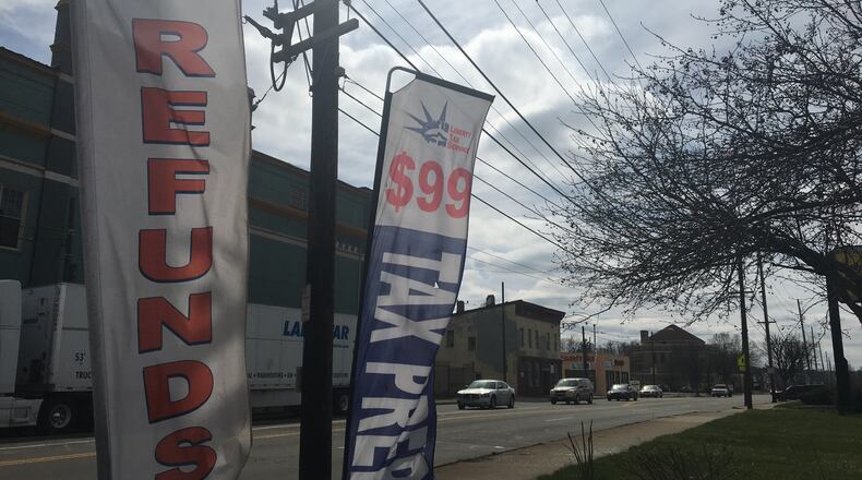 Advertisements for tax preparation services posted along West Third Street in West Dayton. CORNELIUS FROLIK / STAFF