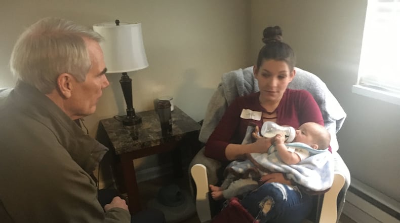 U.S. Senator Rob Portman was in Kettering Monday morning as he paid a visit to the Promise to Hope Maternal Recovery Housing program. He is shown with Amanda Blake and her baby, Xavier.