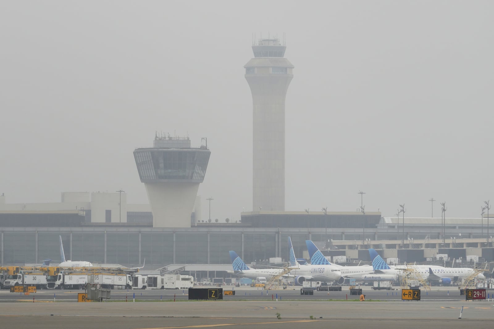 Fog covers planes and control towers at Newark Liberty International Airport in Newark, N.J., Monday, May 5, 2025. (AP Photo/Seth Wenig)