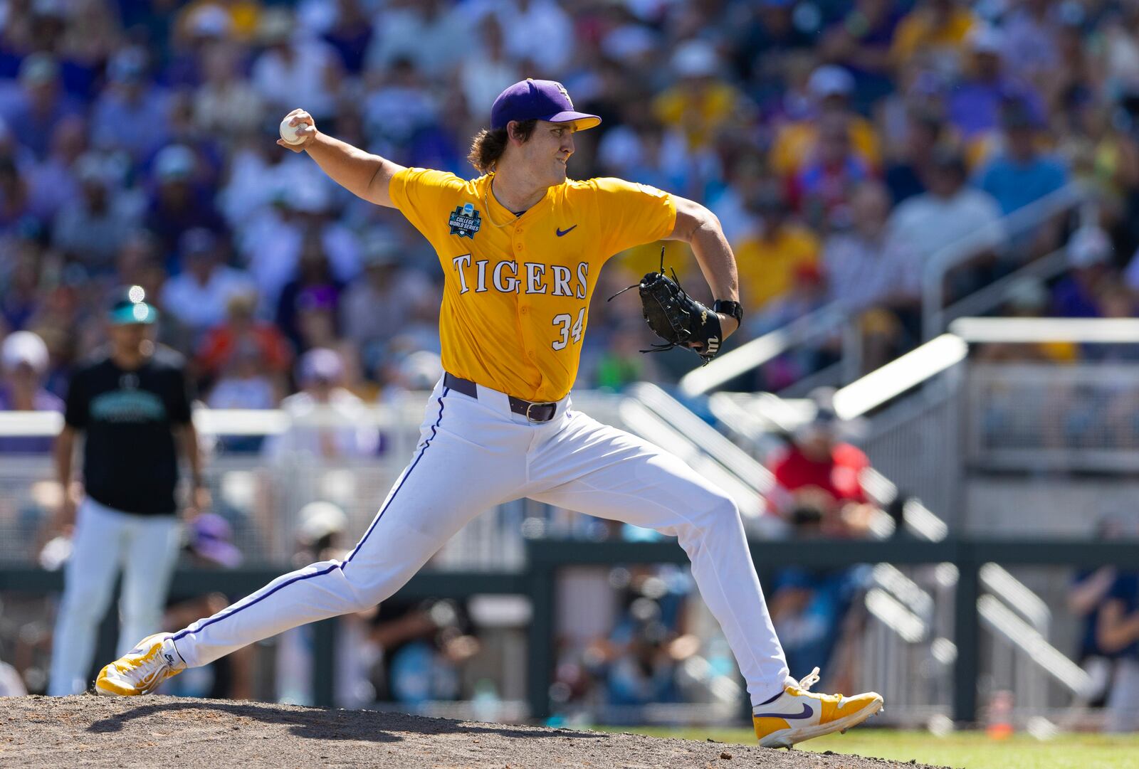 LSU's Chase Shores pitches against Coastal Carolina in the seventh inning of Game 2 of the NCAA College World Series baseball finals in Omaha, Neb., Sunday, June 22, 2025. (AP Photo/Rebecca S. Gratz)