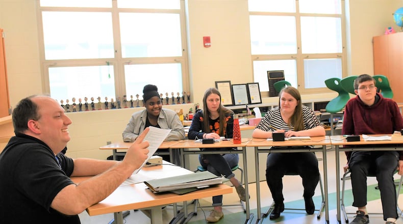 David Jones, left, a teacher at Northmont High School, works with some of the members of the school’s highly successful academic challenge, or quiz bowl, team during a recent after school practice.