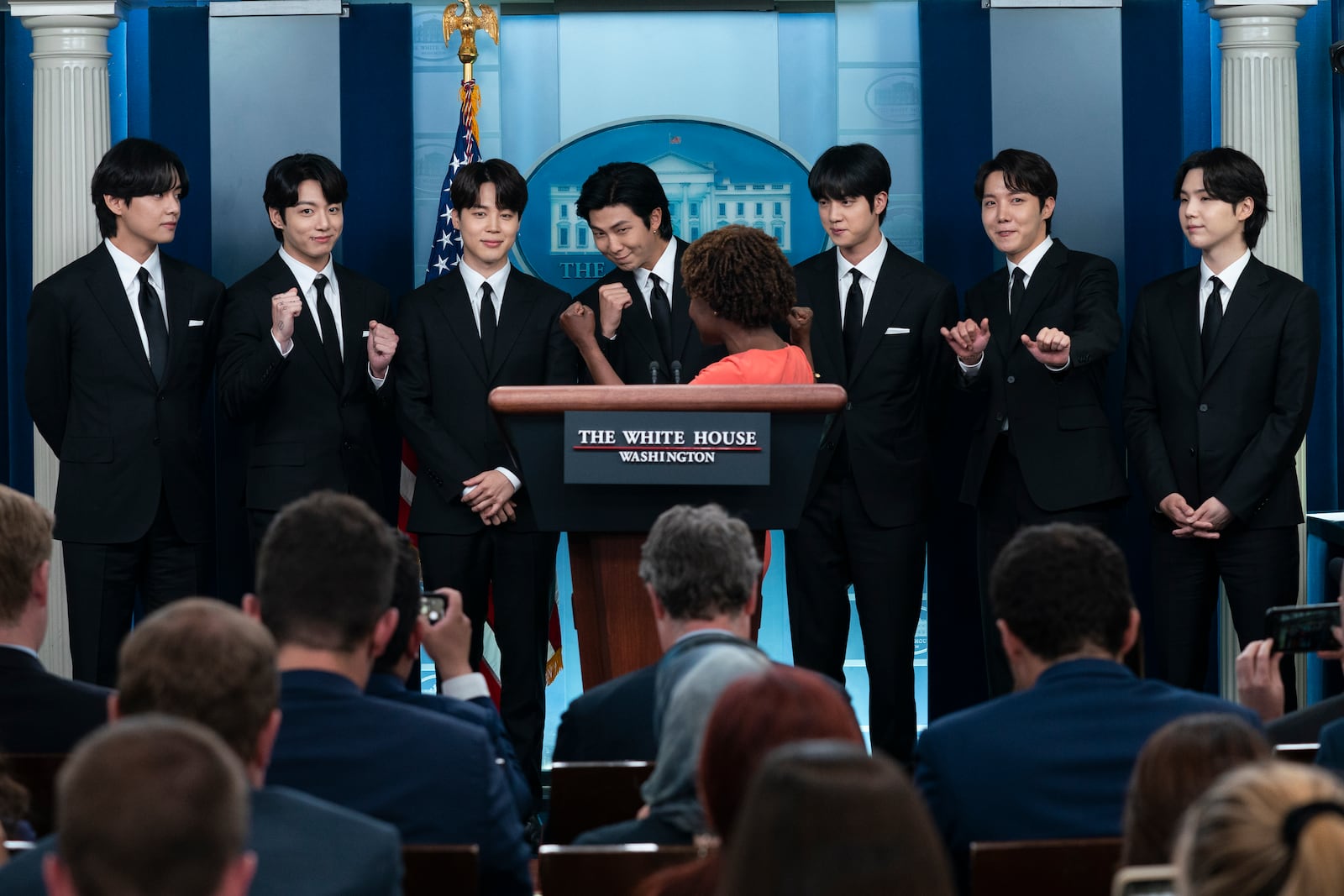 FILE - Members of the K-pop supergroup BTS from left, V, Jungkook, Jimin, RM, Jin, J-Hope, and Suga join White House press secretary Karine Jean-Pierre during the daily briefing at the White House, Tuesday, May 31, 2022, in Washington. (AP Photo/Evan Vucci, File)