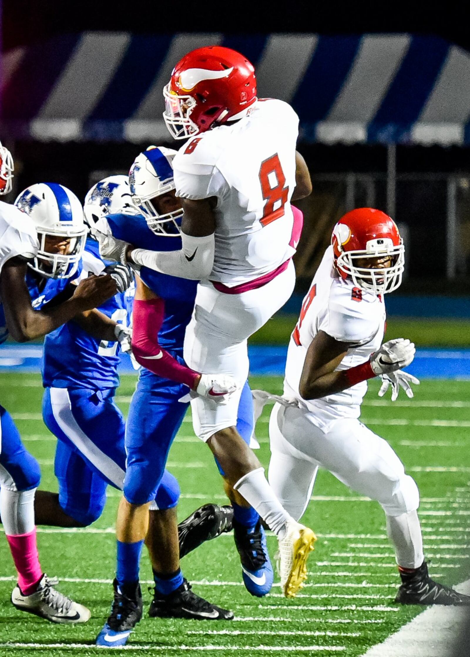 Hamilton’s Gabe Matthews wraps up and tackles Princeton’s Cecil Singleton during Friday night’s game at Virgil Schwarm Stadium in Hamilton. NICK GRAHAM/STAFF