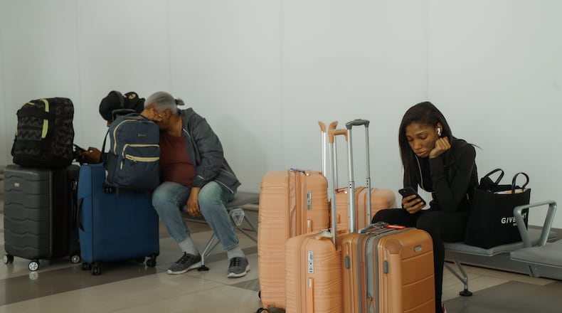 Travelers wait at LaGuardia International Airport on Saturday, Nov. 8, 2025, in New York. (AP Photo/Olga Fedorova)