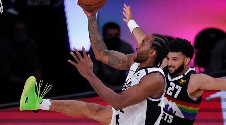 Los Angeles Clippers' Kawhi Leonard (2) shoots against Denver Nuggets' Jamal Murray (27) during the second half of an NBA conference semifinal playoff basketball game, Wednesday, Sept. 9, 2020, in Lake Buena Vista, Fla. (AP Photo/Mark J. Terrill)
