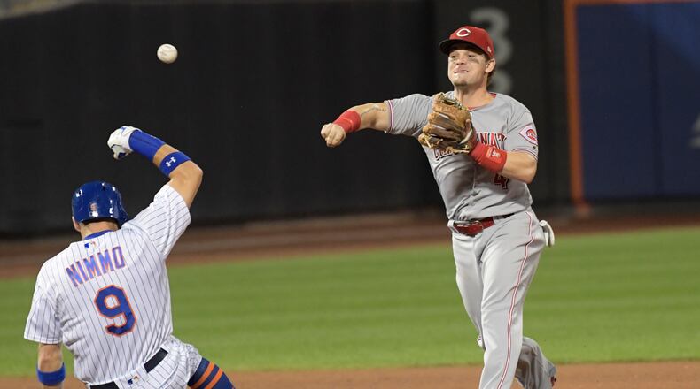 New York Mets’ Brandon Nimmo (9) is out at second as Cincinnati Reds second baseman Scooter Gennett relays the ball to first to complete the double play on Juan Lagares during the fourth inning of a baseball game Saturday, Sept. 9, 2017, in New York. (AP Photo/Bill Kostroun)