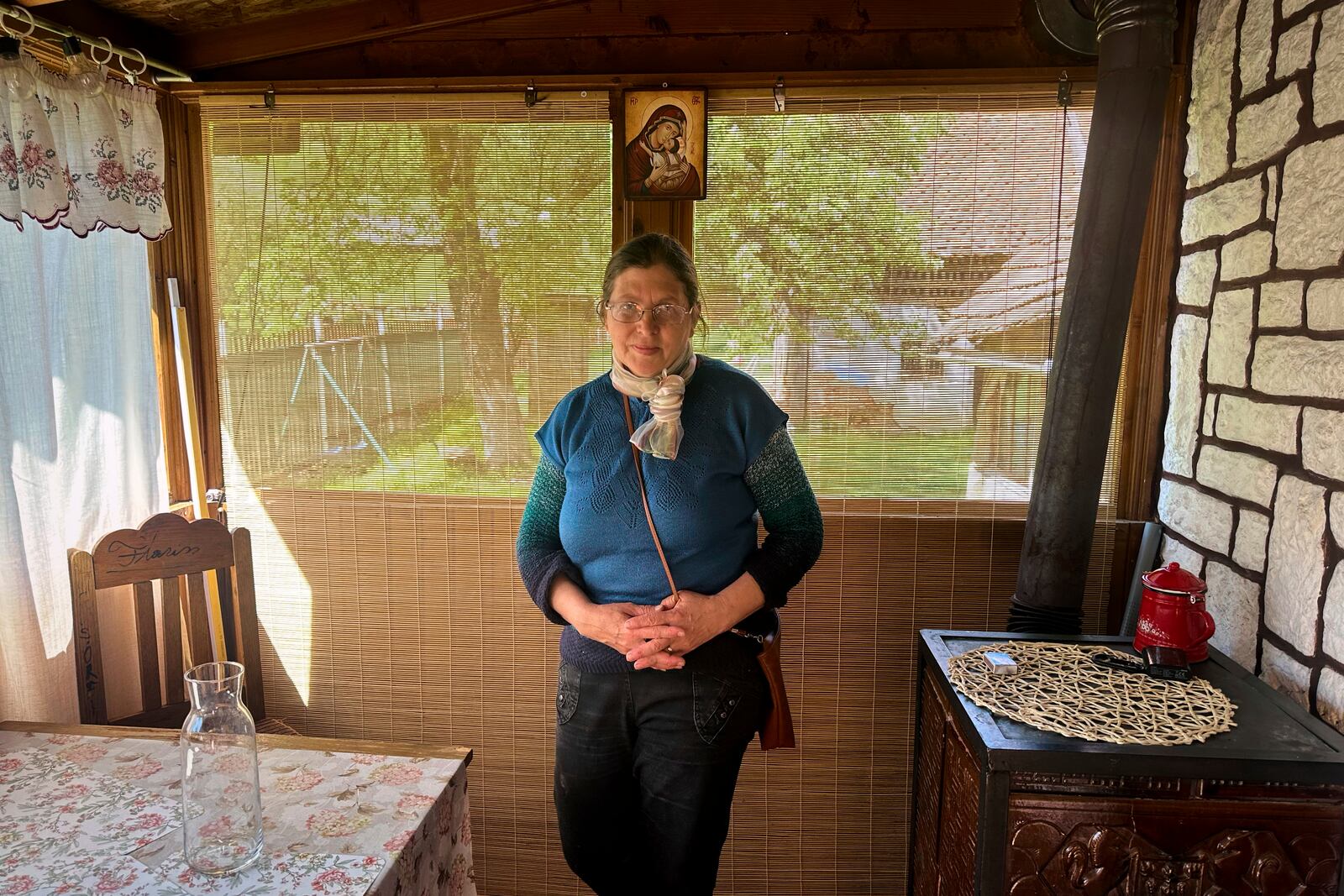 Liliana Cosurean, 54, stands in her home, in the village of Floresti, in Romania's central Transylvania region, Thursday, April 24, 2025. (AP Photo/Stephen McGrath)