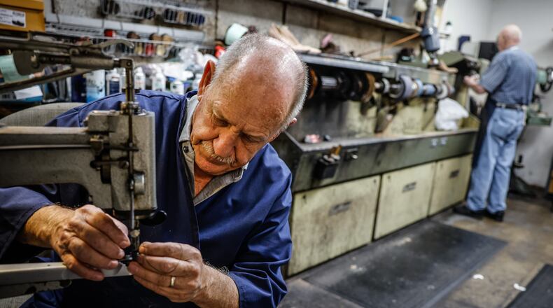 John Strehle works on a soccer shoe at his Kettering store on Woodman Drive. John and his wife, Joyce are closing their store, Strehle's Dry Cleaning & Shoe Repair after 50 of them owner of more than a seven decades old business. JIM NOELKER/STAFF