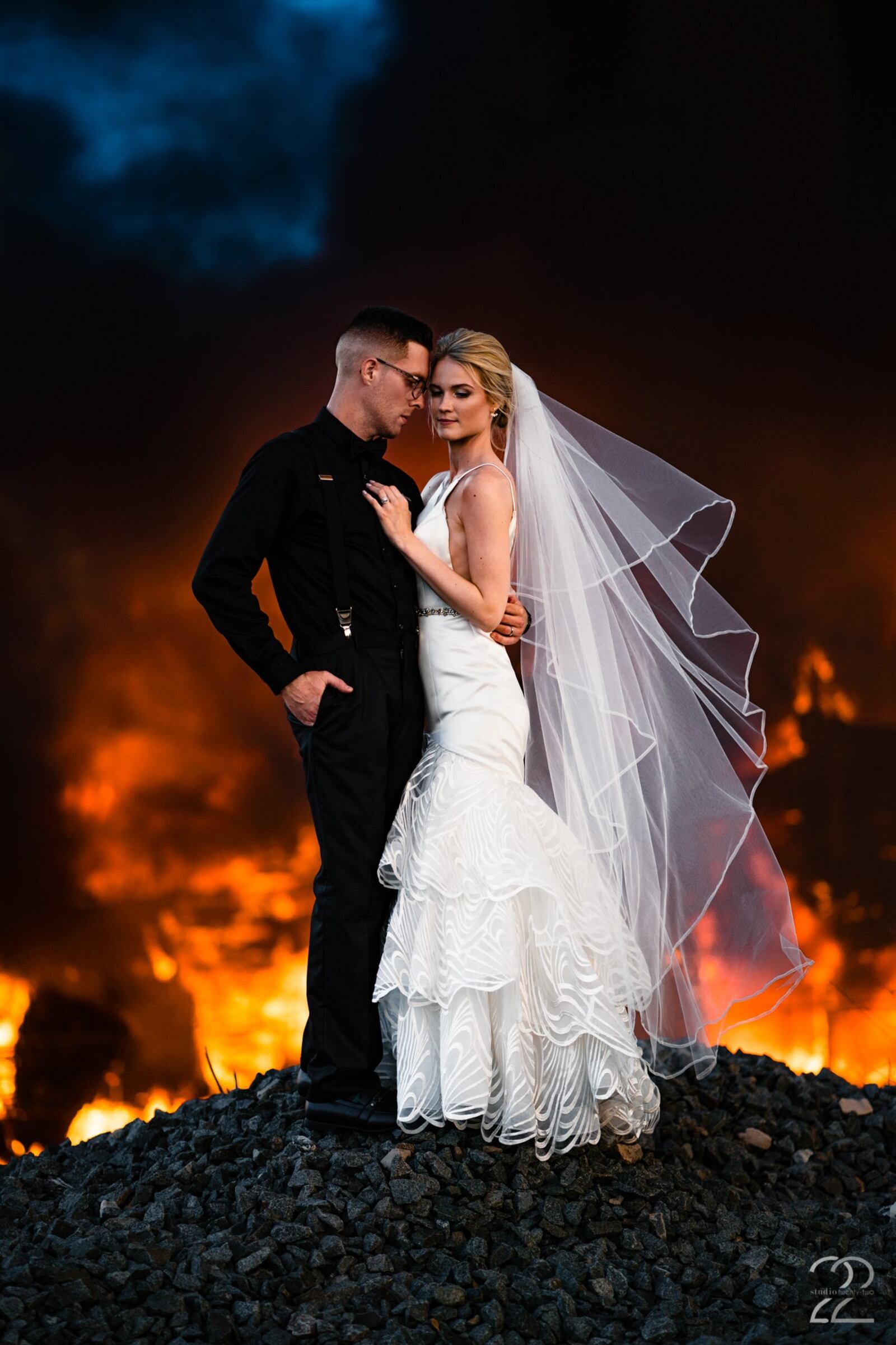 Megan Allen of Studio 22 Photography captures a photo of newlyweds Dillon and Corrie Jameson in front of a burning building in Dayton