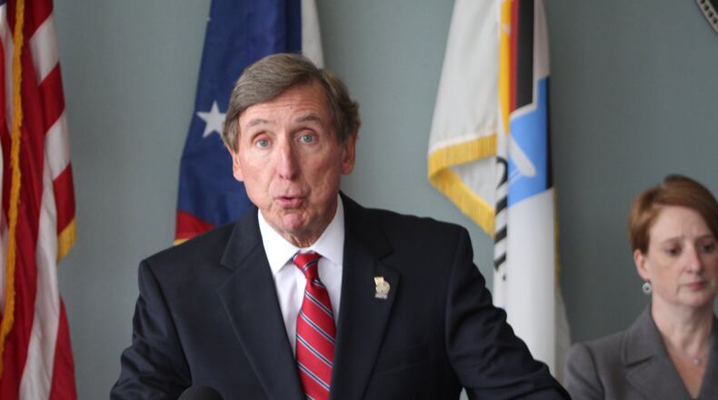 Montgomery County Prosecutor Mat Heck Jr. and Eric Claypoole with the violent crimes bureau at a Monday press conference announcing the indictment against Raymond Walters. CORNELIUS FROLIK / STAFF