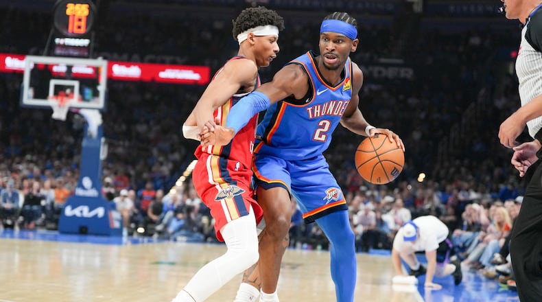 Oklahoma City Thunder guard Shai Gilgeous-Alexander (2) pushes past New Orleans Pelicans guard Jeremiah Fears, left, during the first half of an NBA basketball game, Sunday, Nov. 2, 2025, in Oklahoma City. (AP Photo/Kyle Phillips)