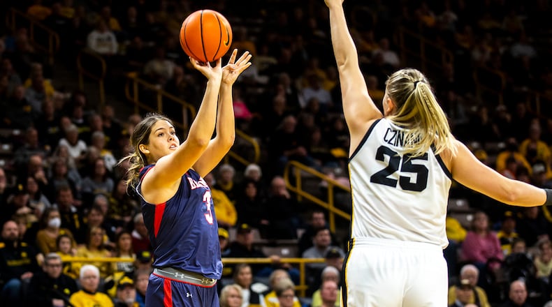 Belmont forward Madison Bartley, left, makes a basket as Iowa center Monika Czinano defends during an NCAA college basketball game, Sunday, Nov. 20, 2022, in Iowa City, Iowa. (Joseph Cress/Iowa City Press-Citizen via AP)