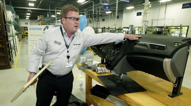 Chris Cooley, manufacturing engineering manager at Inteva Products, talks about how the skin is scored to hide an airbag in a SAAB SUV instrument panel made by Inteva in this 2011 file photo. FILE