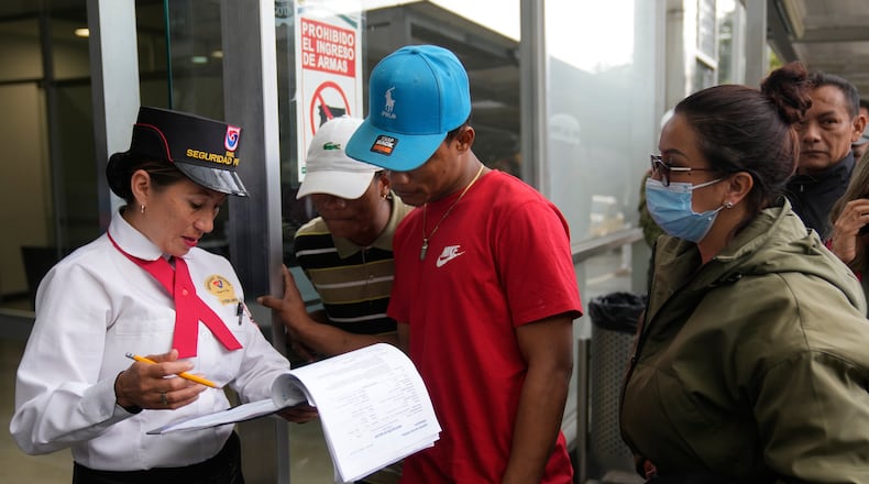 Yeferson de la Hoz, center, the cousin of soldier Mauro Penaranda who was on the cargo plane that crashed the previous day after take off in Puerto Leguizamo, arrives at the military hospital where he is being treated in Bogota, Colombia, Tuesday, March 24, 2026. (AP Photo/Fernando Vergara)