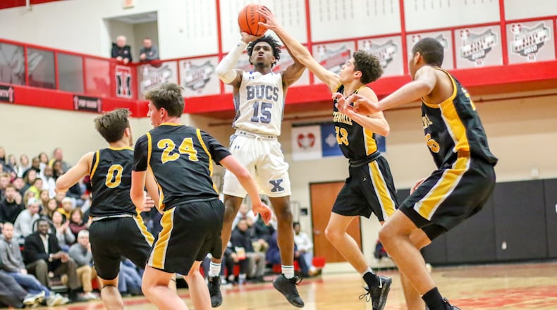 Xenia High School’s Samari Curtis shoots a jumper in front of Centerville’s Jason Sneed during during their Division I sectional final game at Trotwood-Madison High School. The Elks won 63-51. CONTRIBUTED PHOTO BY MICHAEL COOPER