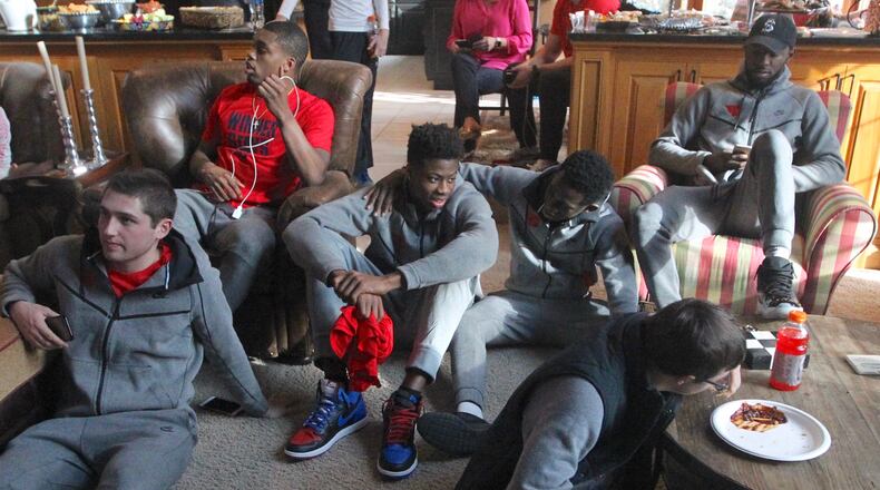 The Dayton Flyers gather at coach Archie Miller’s house on Sunday. David Jablonski/Staff