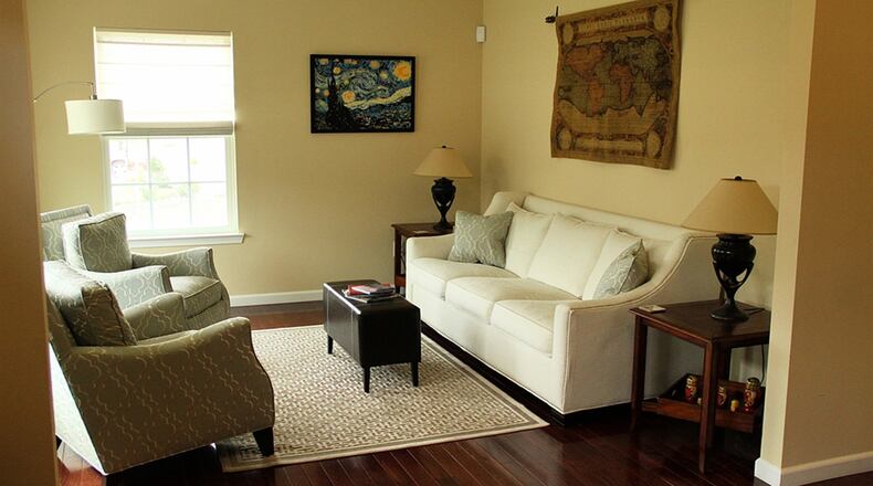 Hardwood flooring extends left and right from the entry into the open living room and the office.