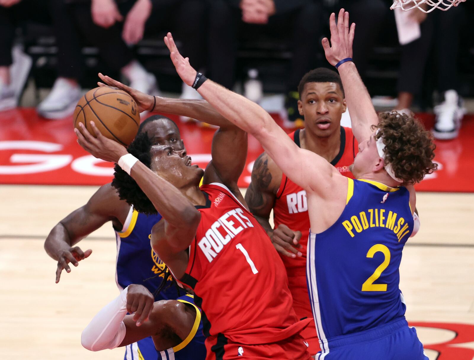 Golden State Warriors' Brandin Podziemski (2) defends Houston Rockets' Amen Thompson (1) during the first half of Game 1 of an NBA basketball first-round playoff series in Houston, Sunday, April 20, 2025. (Scott Strazzante/San Francisco Chronicle via AP)