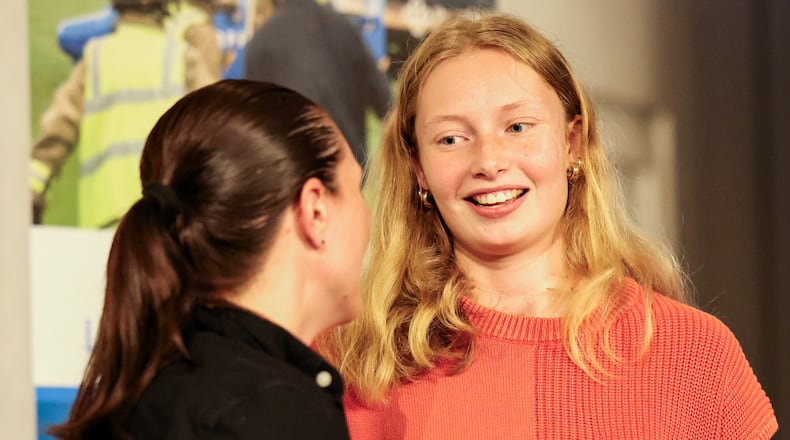 Brooke Bergman talks with a nurse who was on her care team shortly after being presented with a gift bag during Miami Valley Hospital's Trauma Survivor celebration on Tuesday, Oct. 7 at Marriott at University of Dayton. Bergman, a Versailles High School student, was hit by a semi after leaving school in 2024. BRYANT BILLING / STAFF