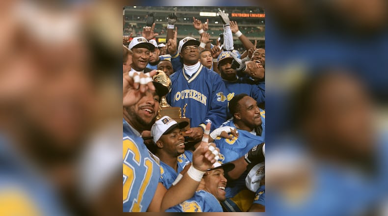 951229--ATLANTA, GA:--Southern University coach Pete Richardson celebrates with his team after defeating Florida A&M to win the Heritage Bowl, Saturday December 29, 1995 at the Georgia Dome in Atlanta. (Marlene Karas/AJC Staff)