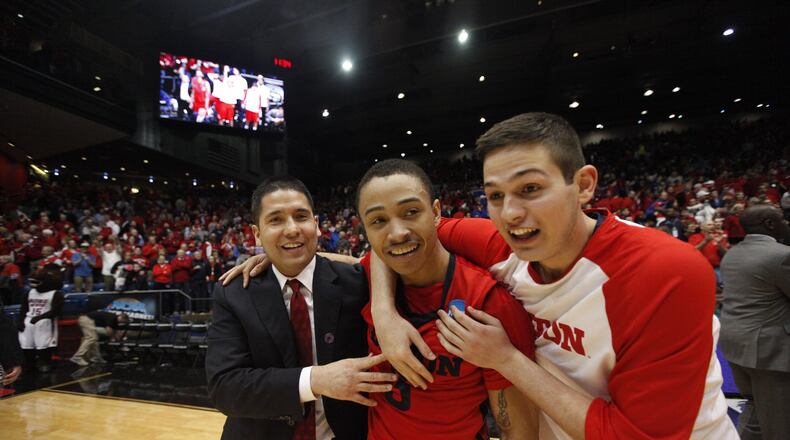 Dayton assistant coach Tom Ostrom, Kyle Davis and Nick Haldes celebrate after a victory against Boise State in the First Four on Wednesday, March 18, 2015, at UD Arena. David Jablonski/Staff