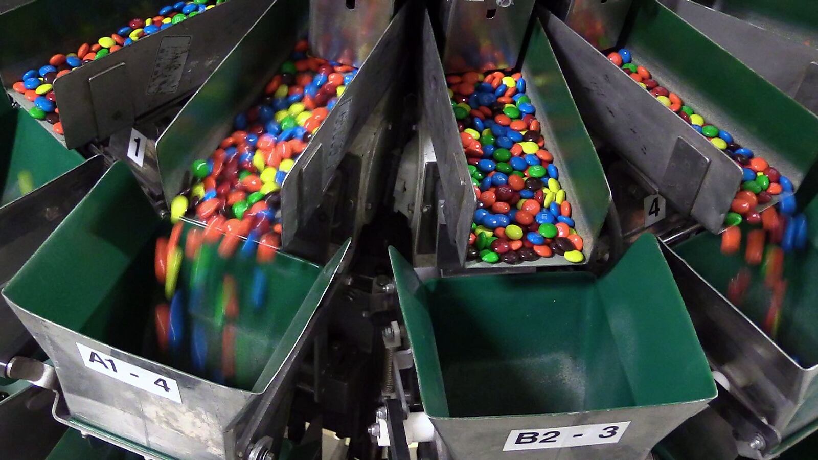 M&M's fall into a chute that sends them into individual packages at the Mars Chocolate plant in Hackettstown, N.J., on March 1, 2016. The M&M's brand turns 75 on Thursday.