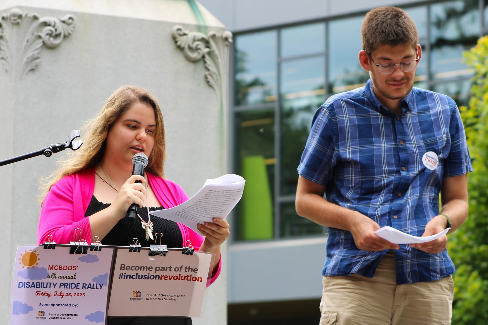 Joe Seifert prepares to share his experiences as event emcee Sierra Ward introduces him to a large crowd at Cooper Park in Dayton on Friday, July 25. STAFF/SYDNEY DAWES