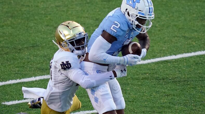 North Carolina wide receiver Dyami Brown (2) catches a pass as Notre Dame cornerback TaRiq Bracy (28) defends during the first half of an NCAA college football game in Chapel Hill, N.C., Friday, Nov. 27, 2020. (AP Photo/Gerry Broome)