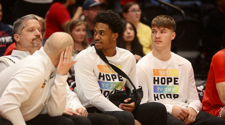 Dayton's Jaron McKie, center, watches from the bench during a game against Penn State in an exhibition game on Sunday, Oct. 19, 2025, at UD Arena. David Jablonski/Staff