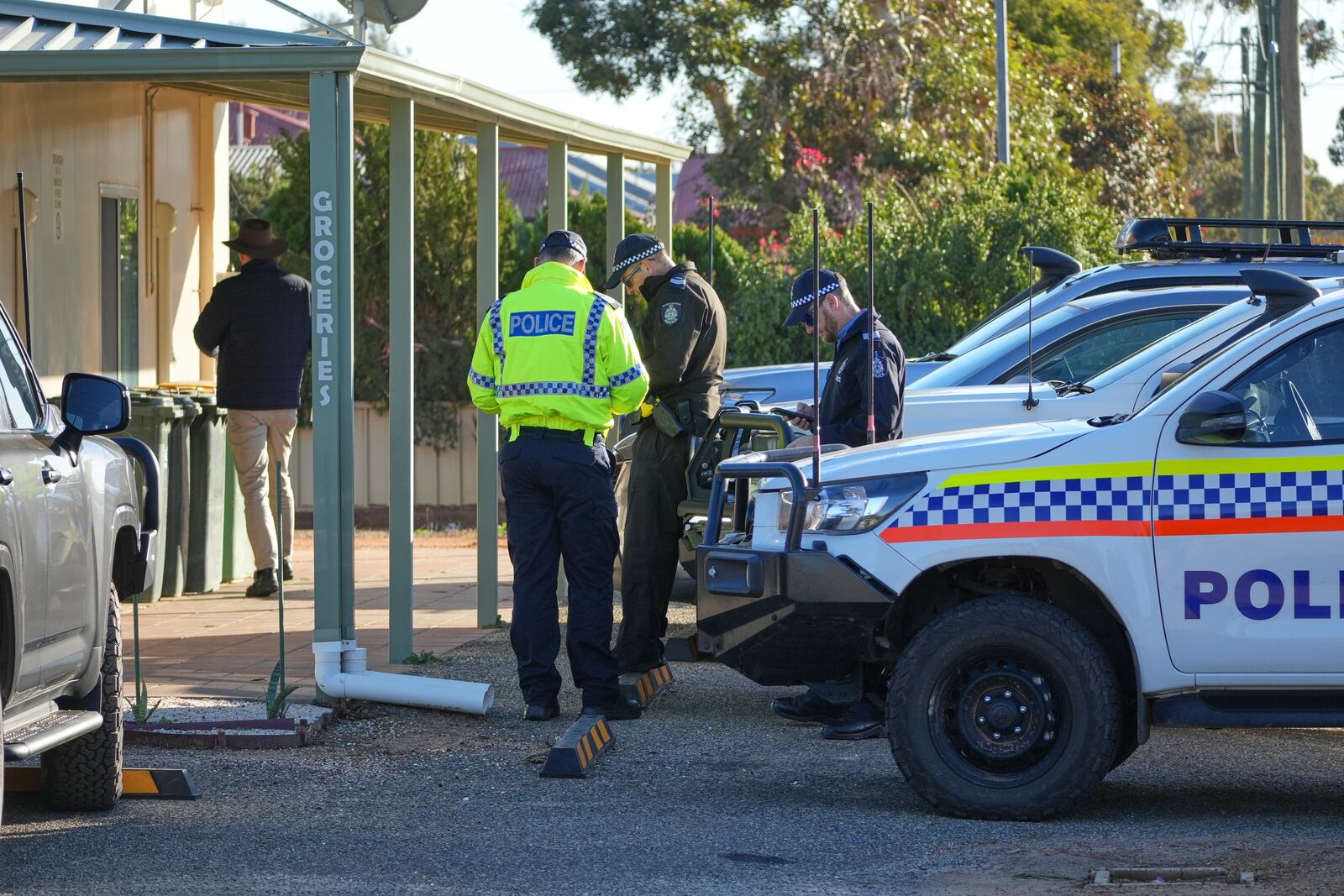 Police officers gather in Beacon, Western Australia, Friday, July 11, 2025, as they prepare to search for missing German backpacker Carolina Wilga. (ABC News via AP)
