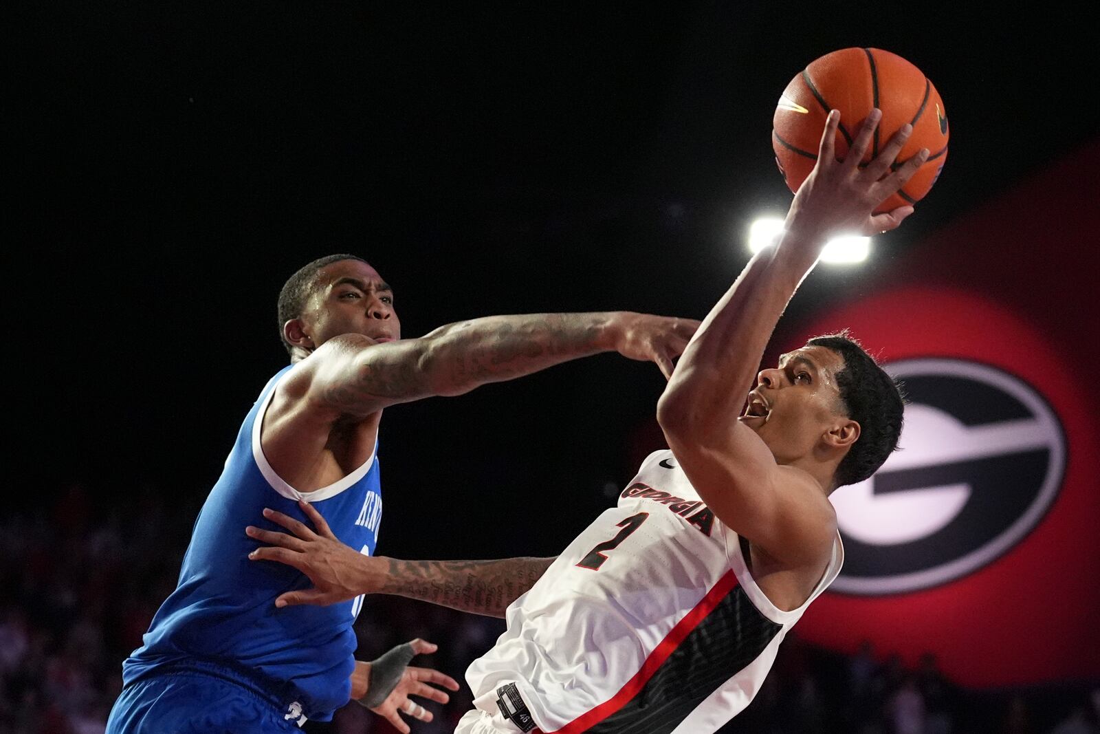 Kentucky forward Brandon Garrison (10) fouls Georgia guard De'Shayne Montgomery (2) during the second half of an NCAA college basketball game, Tuesday, Jan. 7, 2025, in Athens, Ga. (AP Photo/Brynn Anderson)