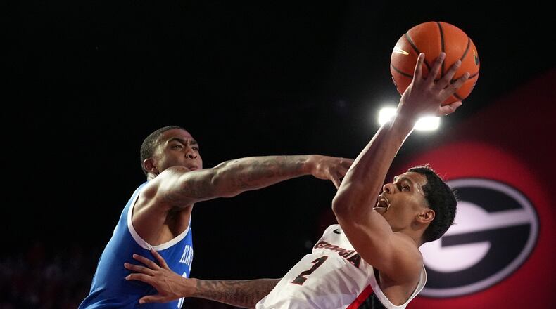 Kentucky forward Brandon Garrison (10) fouls Georgia guard De'Shayne Montgomery (2) during the second half of an NCAA college basketball game, Tuesday, Jan. 7, 2025, in Athens, Ga. (AP Photo/Brynn Anderson)