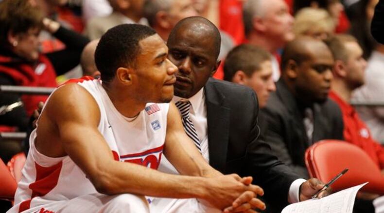 Dayton assistant coach Allen Griffin, right, talks to Vee Sanford on Sunday, Dec. 29, 2013, at UD Arena.